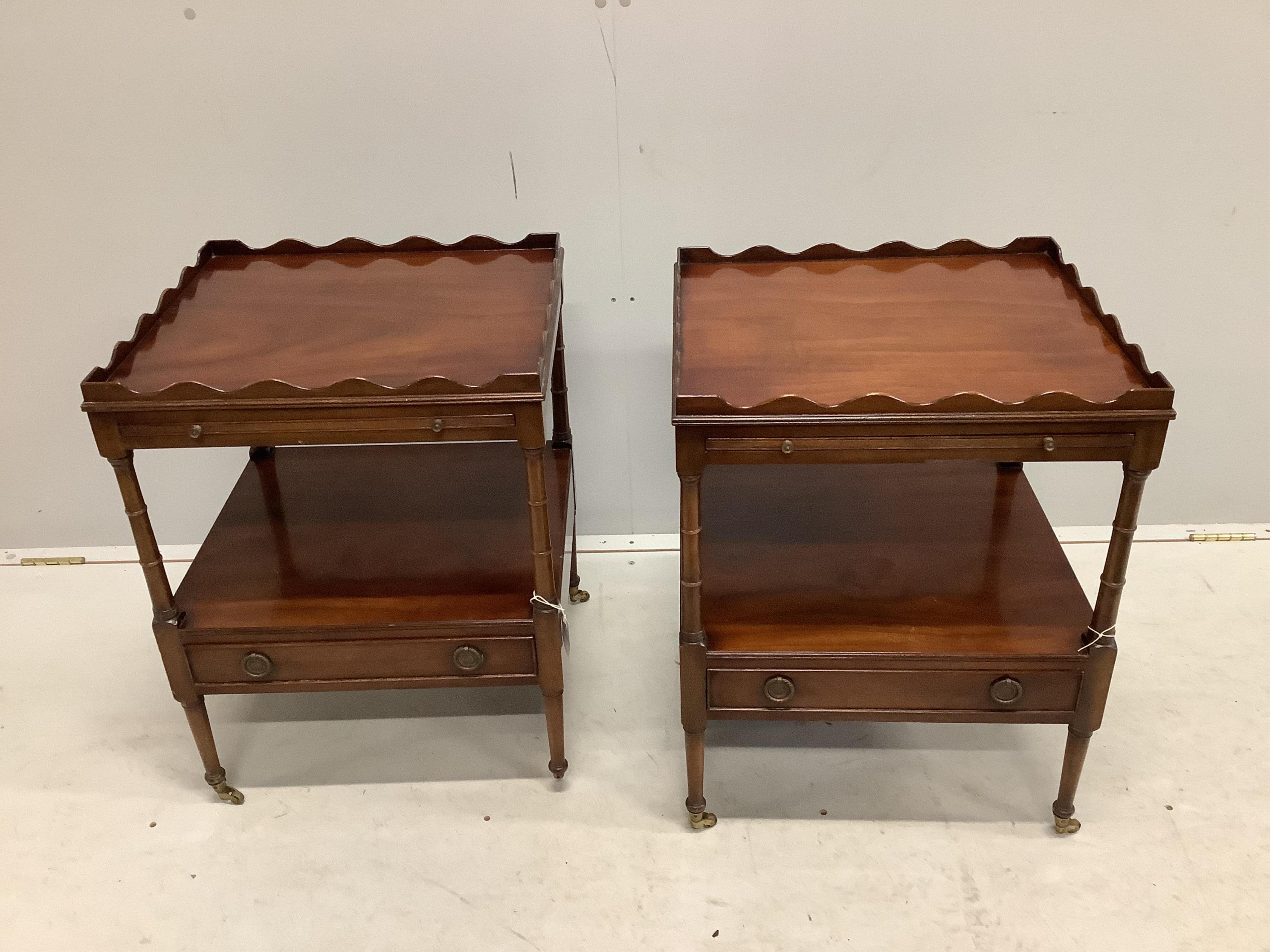 A pair of reproduction mahogany two tier tables fitted slides on ring turned legs, width 48cm, depth 44cm, height 63cm. Condition - fair but lacking one brass cup castor